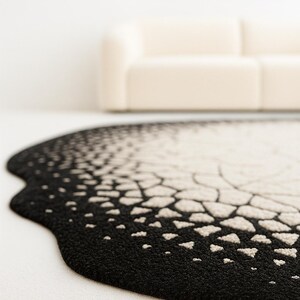 Detail macro shot showing smooth silk sheen and wool fibers of the eclipse design.