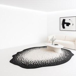 Side angle showing low pile height and clean edges of the cracked eclipse abstract rug.