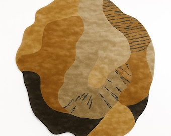 May include: A round rug with an abstract design in shades of brown, tan, and black. The rug features organic shapes and patterns, including a section with tiger stripe-like markings. The rug is a decorative floor covering.