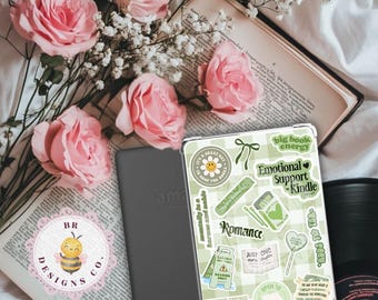 May include: An Amazon Kindle e-reader with a green and white checkered case covered in stickers, including "Emotional Support Kindle" and "Romance." Pink roses and an open book are in the background. The Kindle is next to a logo with a bee.