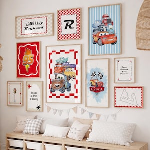May include: A gallery wall featuring ten framed prints with Disney Pixar Cars themes, including illustrations of Lightning McQueen and Mater, a red 95 lightning bolt, a traffic light, and text prints reading Long Live Boyhood and Race Toward Your Dreams.