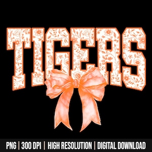 May include: Orange and white floral design with the word "TIGERS" in white letters. A large orange bow is centred below the word.