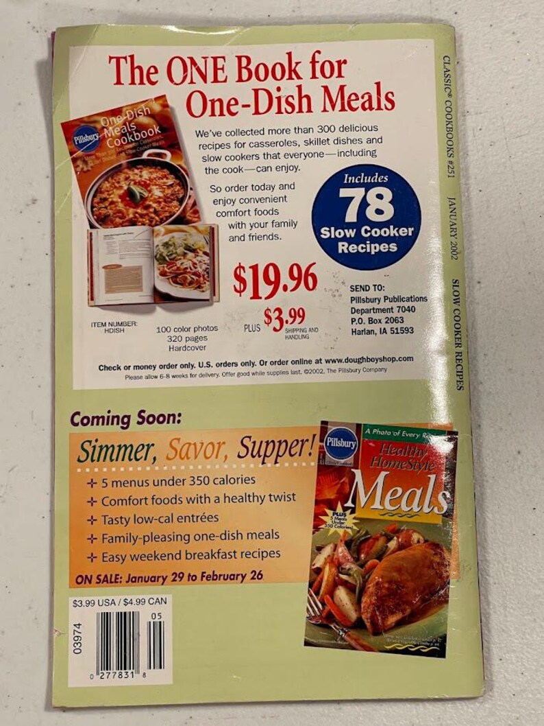 May include: The back cover of a cookbook titled "The ONE Book for One-Dish Meals" with a photo of a casserole. It includes 78 slow cooker recipes and features a hardcover with 320 pages and 100 color photos. The book also advertises a new cookbook.
