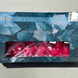 May include: A box of 10 Ct String Lights for indoor/outdoor use. The box has a blue and white leaf design. The string lights are red. Lighted length is 67.5 inches (171 cm), total length is 98.5 inches (250 cm).