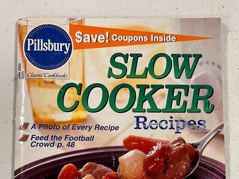 May include: A Pillsbury cookbook titled "Slow Cooker Recipes" with a photo of a recipe on the cover. The cover features the Pillsbury logo, text that says "Save! Coupons Inside", and the text "Feed the Football Crowd p. 48".