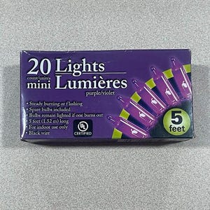 May include: A box of 20 mini purple lights, labeled "Lights mini Lumières." The box is purple with a graphic of the lights and the text "5 feet." Includes spare bulbs and black wire. For indoor use only.