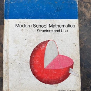 May include: A vintage textbook titled "Modern School Mathematics Structure and Use" with a blue cover and a red, white, and pink graphic. The book is part of the California State Series.