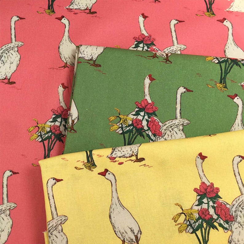 May include: Three fabric swatches with a repeating pattern of white geese with red beaks and feet. The geese are surrounded by red flowers and yellow foliage. The fabrics are in shades of pink, green, and yellow.