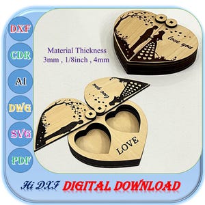 May include: Laser-cut wooden heart-shaped box with a hinged lid, featuring a silhouette of a couple under a tree and the words "love you." The box is open, revealing two heart-shaped compartments and the word "LOVE." The text "Hi DXF DIGITAL DOWNLOAD" is also visible.