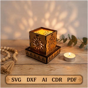 May include: A square wooden candle holder with intricate laser-cut floral patterns on each side, resting on a matching square base. The holder emits a warm glow from within. A text banner at the bottom displays the file formats: SVG, DXF, AI, CDR, PDF.