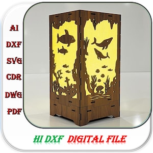 Könnte beinhalten: Eine rechteckige Holzlampe mit lasergeschnittenen Paneelen, die Silhouetten von Walen, Fischen und Korallenriffen zeigen und ein warmes gelbes Licht ausstrahlen. Der Text AI, DXF, SVG, CDR, DWG, PDF und HI DXF DIGITAL FILE ist deutlich zu sehen.
