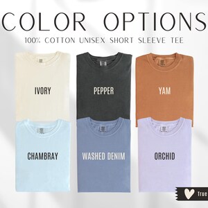 May include: Image showcasing six short-sleeve t-shirts in various colors: ivory, pepper, yam, chambray, washed denim, and orchid. The text "COLOR OPTIONS" and "100% COTTON UNISEX SHORT SLEEVE TEE" are displayed at the top. The brand logo is at the bottom.