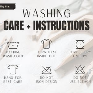 May include: Image with washing instructions. Text includes "WASHING CARE + INSTRUCTIONS" and icons for machine wash cold, turn item inside out, tumble dry on low, hang for best care, do not iron design, and do not use bleach. Wooden clothespins are in the background.