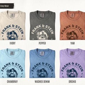 May include: A collection of six t-shirts in various colors, including ivory, pepper, yam, chambray, washed denim, and orchid. Each shirt features the "FRANK & STEIN" logo with a beer-holding figure and the text "INGOLSTADT BREWING CO."