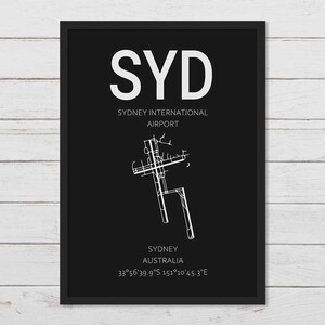 May include: Black and white airport diagram print with the text "SYD" for Sydney International Airport, Sydney, Australia, and the coordinates 33&deg;56'39.9"S 151&deg;10'45.3"E.