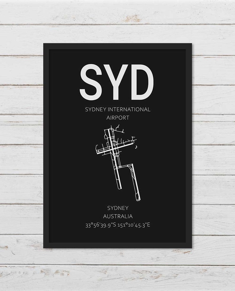 May include: Black and white airport diagram print with the text "SYD" for Sydney International Airport, Sydney, Australia, and the coordinates 33&deg;56'39.9"S 151&deg;10'45.3"E.