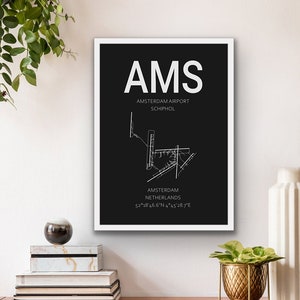 May include: A black and white airport map print with the text "AMS Amsterdam Airport Schiphol Amsterdam Netherlands 52&deg;18&prime;46.6&Prime;N 4&deg;45&prime;28.7"E".