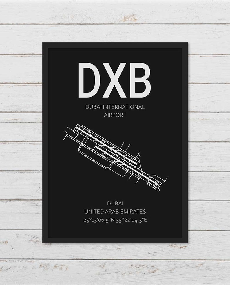 May include: A black and white airport map print with the text "DXB" in large white letters. The text "Dubai International Airport" is below the airport code. The map shows the layout of Dubai International Airport in the United Arab Emirates. The coordinates 25&deg;15'06.9"N 55&deg;22&prime;04.5"E are listed below the airport name.
