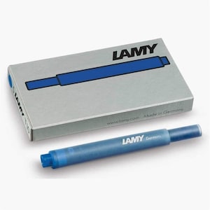 May include: A pack of blue ink cartridges for fountain pens. The pack is silver with the word "LAMY" printed in black. The cartridges are blue and have the word "LAMY" printed in white. The pack says "Made in Germany" and "www.lamy.com".