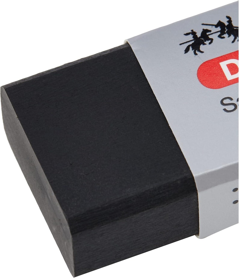 May include: A rectangular black eraser with a silver and red label. The label features a silhouette of horsemen and the letter "D". The eraser has a slightly curved edge.