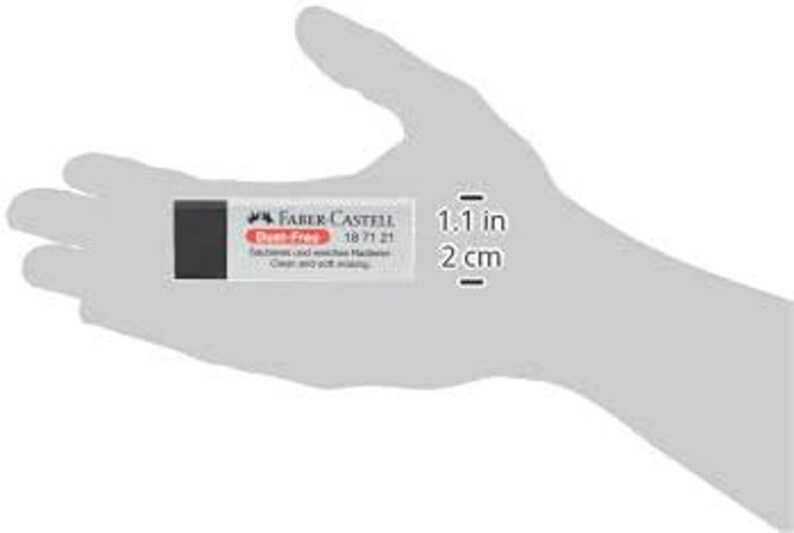 May include: A rectangular Faber-Castell Dust-Free eraser, 1.1 inches long, held in a hand. The eraser has a black and white design with the brand name and product details printed on the front. The eraser is designed for clean and soft erasing.