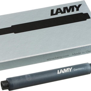 May include: A black ink cartridge for a fountain pen, labeled "LAMY Germany" and "www.lamy.com Made in Germany".