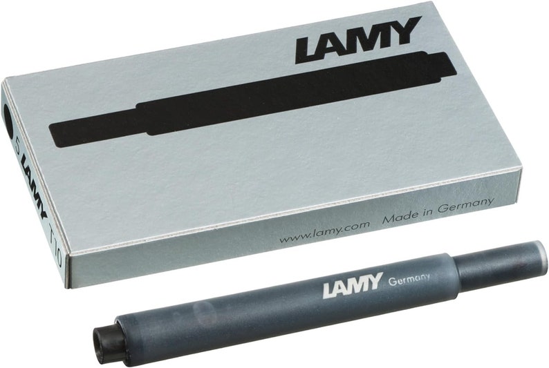 May include: A black ink cartridge for a fountain pen, labeled "LAMY Germany" and "www.lamy.com Made in Germany".