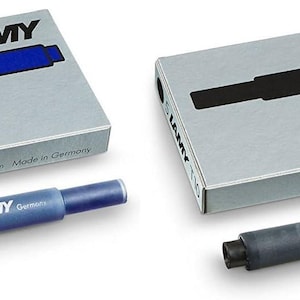 May include: Two packs of blue and black ink cartridges for fountain pens. The packs are silver with the LAMY logo and the words "Made in Germany". The cartridges are blue and black.