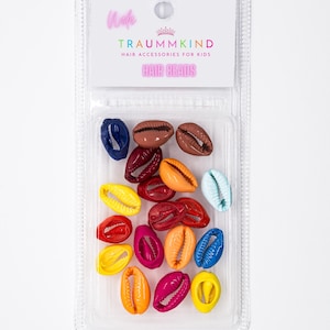 Op de afbeelding: Een verpakking met kleurrijke schelpvormige haar kralen. De verpakking is gelabeld met "Traummkind Hair Accessories for Kids" en "Hair Beads".