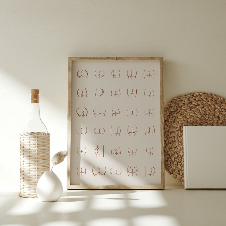 May include: A framed print with a white background and brown lines forming various shapes. The print is hanging on a white wall with a wicker bottle holder, a clear glass bottle, and a white vase with a dried plant stem.