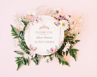 May include: A round invitation card with the text "THANK YOU FOR COMING TO Lucia Valeria's QUINCEAÑERA" surrounded by pink and white flowers, butterflies, and green leaves. The background is a soft pink.