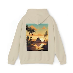 May include: A beige hoodie with a graphic print of a sunset scene with palm trees and pyramids reflected in a body of water.