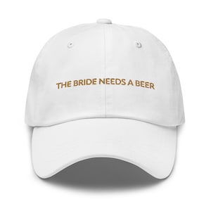 May include: White baseball cap with the text "THE BRIDE NEEDS A BEER" embroidered in brown.