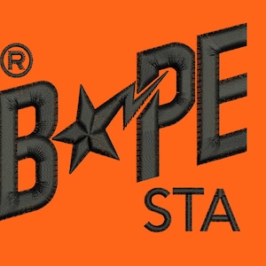 May include: Black and white embroidered logo with the text "BAPE STA" on an orange background.