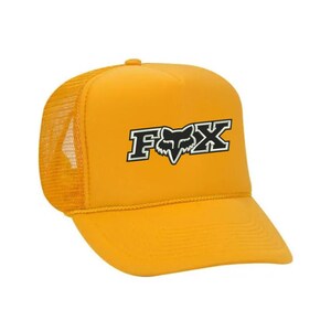 May include: A yellow trucker hat with a black and white Fox logo.