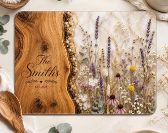 May include: A rectangular serving board featuring a natural wood section on the left with the engraved text The Smiths EST. 2026 and a white resin section on the right embedded with dried purple, yellow, and white wildflowers and gold flakes.