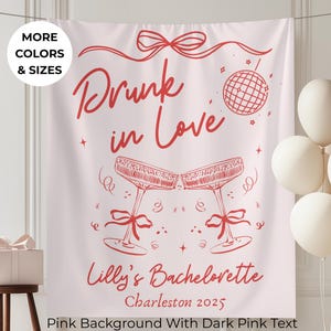May include: Pink backdrop with dark pink text that reads "Drunk in Love" with champagne glasses, a disco ball, and the text "Lilly's Bachelorette Charleston 2025". White balloons and a gift box are also visible.