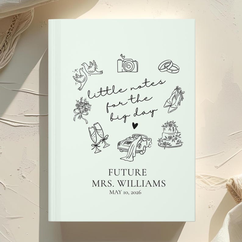 May include: A light green wedding journal with black line art illustrations of wedding-related icons, including rings, a camera, and a cake. The text "little notes for the big day" is featured, along with the names "MRS. WILLIAMS" and the date "MAY 10, 2026".