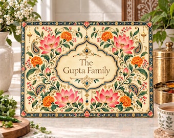 May include: A rectangular sign with a cream background featuring a central ornate frame containing the text The Gupta Family. The border is decorated with symmetrical illustrations of pink lotus flowers, orange marigolds, and blue paisley motifs.