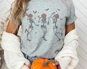 Pumpkin Head Skeleton Dance T-Shirt – Funny Halloween Unisex Tee, Spooky Season Fall Shirt, Cute Skeleton Graphic Tee with Bats