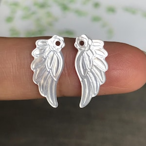 May include: A set of three ceramic mugs with a speckled, matte finish. The mugs are in shades of cream, light gray, and dark gray. Each mug has a simple, minimalist design, perfect for coffee or tea.