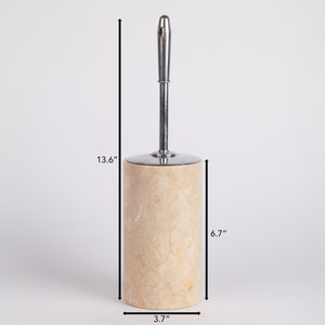 May include: A beige marble toilet brush holder with a chrome handle. The holder is 13.6 inches tall, 6.7 inches wide, and 3.7 inches in diameter.