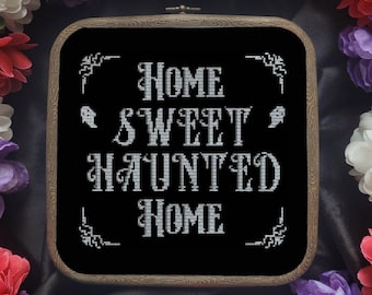 May include: A black framed embroidery hoop with white text that reads "Home Sweet Haunted Home" with two ghost silhouettes.