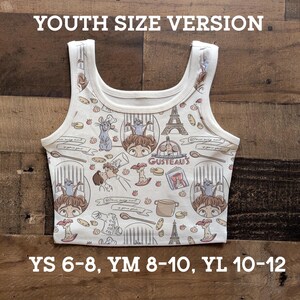 May include: White youth-size tank top with a repeating pattern of cartoon characters, food, and the Eiffel Tower. The text "GUSTEAU'S" is visible. Sizes YS 6-8, YM 8-10, and YL 10-12 are listed.
