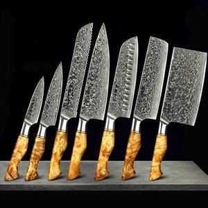 May include: Set of eight kitchen knives with wooden handles. The knives have a Damascus steel blade pattern and include a chef's knife, a bread knife, a paring knife, and a utility knife.