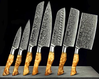 May include: Set of eight kitchen knives with wooden handles. The knives have a Damascus steel blade pattern and include a chef's knife, a bread knife, a paring knife, and a utility knife.