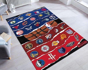 May include: A red and blue basketball rug featuring the logos of all the NBA teams. The rug is split into two sections, one for the Eastern Conference and one for the Western Conference. The rug is made from a soft, durable material and is ideal for any basketball fan.
