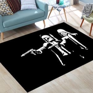 May include: Black and white rug with a silhouette of two Star Wars characters, Darth Vader and Boba Fett, standing side by side. The characters are wearing suits and holding guns.