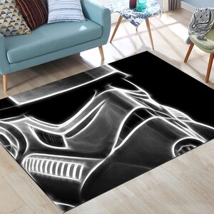 May include: Black and white area rug with a white outline of a Star Wars Stormtrooper helmet.