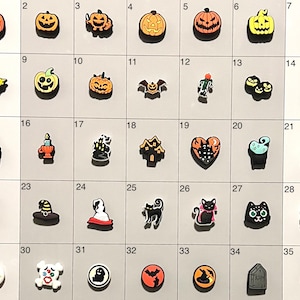 May include: A set of 35 Halloween-themed charms, featuring pumpkins, ghosts, bats, witches, and other spooky designs. The charms are made of plastic and come in a variety of colors.